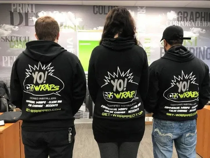 Three members of the CL Visual crew in matching CLV Wraps hoodies