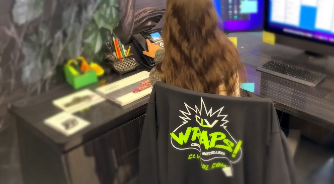 CL Visual team member at her desk, wearing a CLV Wraps Certified Installers shirt