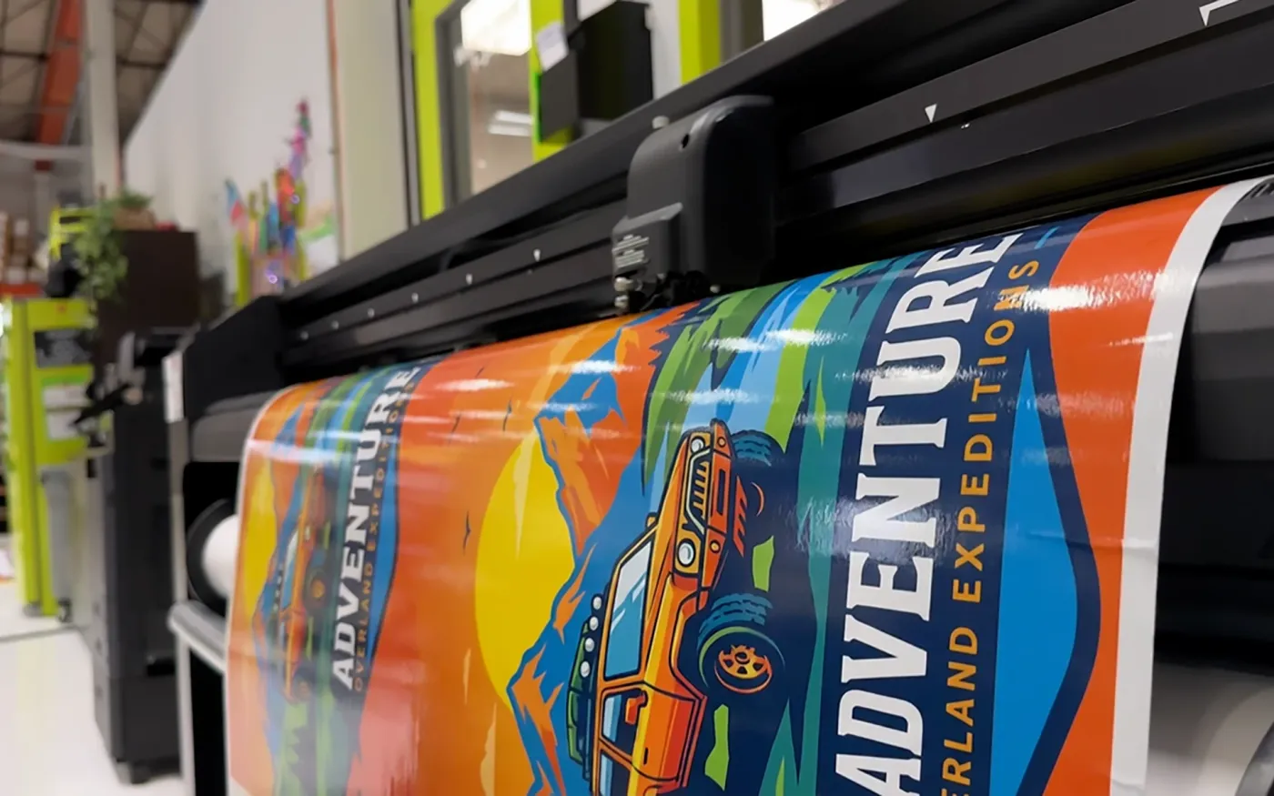 Wide-format printer producing a full-color banner at CL Visual