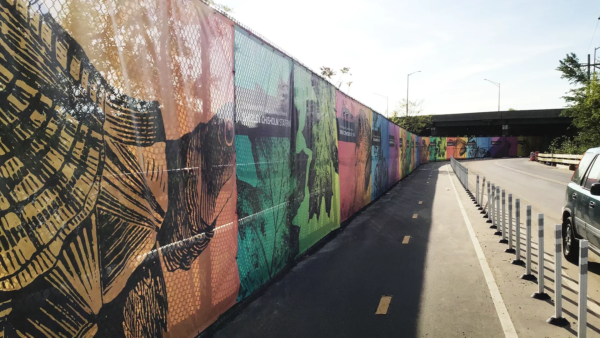 Printed mesh fence banner with nature artwork along the fence at Shirley Chisholm State Park, Brooklyn